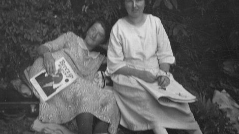 Two women pose for a photo while reading magazines, including the January 1924 number of "Breezy Stories."