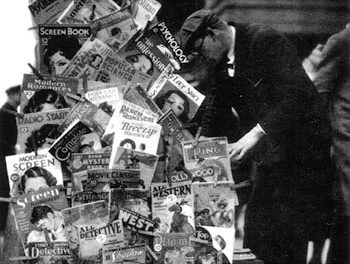 Pulps and a few “slicks” are clipped to the side of this magazine rack in New York City in November 1932.