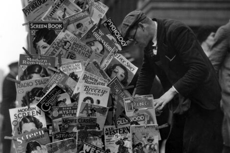 Pulps and a few “slicks” are clipped to the side of this magazine rack in New York City in November 1932.