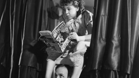 John Qualen and Jane Withers, who play father and daughter in the movie "Angel's Holiday," pose in this publicity photo from 1936 featuring the fictitious pulp "Lurid Detective Magazine."