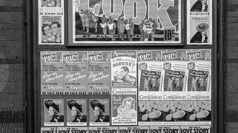 Posters for "Love Story Magazine" line the bottom of this wall of magazine advertisements in Washington, D.C., in early 1938.