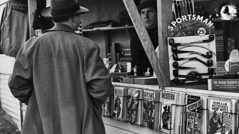 Another man talks to a vendor at a newsstand in Burbank, Calif., in early 1941. Pulps dated February 1941 are on display.