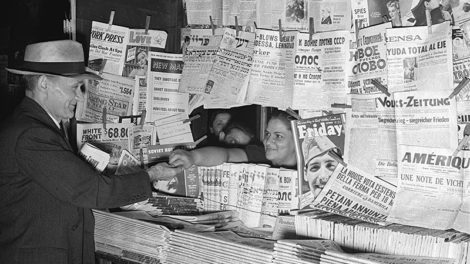 At first, there appear to be no pulp magazines for sale at the newsstand displaying a variety of foreign newspapers dated mid-August 1941. But, if you look below the "Friday" magazine, you'll see dozens of pulp magazines displayed spines up.