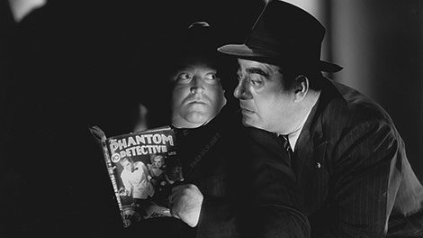 Actors Tom Moffat (left) and Dewey Robinson pose with a September 1941 copy of "The Phantom Detective" in a publicity photo for the 1945 comedy "Pardon My Dust."