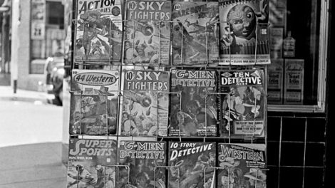 Also from July 1942, this rack in Yreka, Calif., displays the headline of the day above a selection of pulp magazines.