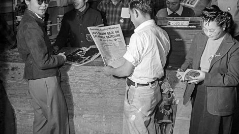 Pulps — including "Love Story," "Argosy," and "Thrilling Adventures" — are for sale on wall racks behind the counter of a news shop in Manzanar War Relocation Center, another Japanese American internment camp near Independence, Calif., in February 1943.