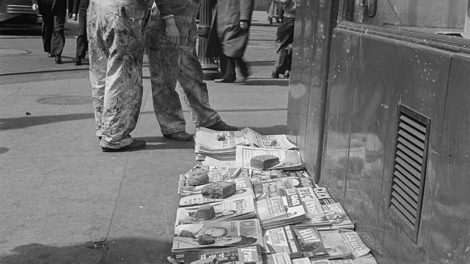 Among the newspapers and magazines for sale at the corner of E Baltimore and N Holliday streets in Baltimore in March 1943 is an issue of "Fighting Aces" (at the very bottom of the image).
