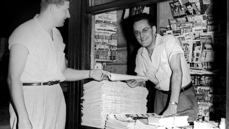 No pulp covers are on display among the comic books and magazines in this newsstand in 1951, but there is a stack of pulps (with their spines facing out) on a shelf just between the two men. Titles include "Best Sports," "New Love," Smashing Detective Stories," "Fifteen Love Stories," "Fifteen Sports Stories," "Exciting Western," and "Famous Detective Stories."