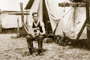 A man, possibly a soldier, reads Adventure (August 1915).