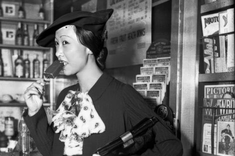Anna May Wong, considered the first Chinese-American film star in Hollywood, enjoys an ice cream bar at LaSalle Station in Chicago on July 21, 1934. Over her left should is the August 1934 number of "Astounding Stories."