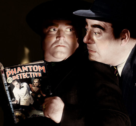 Actors reading a copy of "The Phantom Detective" pulp magazine