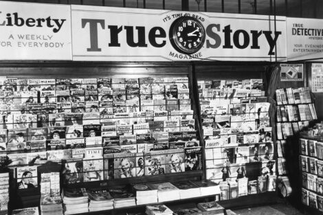 Beneath advertising for "Liberty," "True Story," and "True Detective" magazines, this magazine rack displays a number of pulp magazines from early 1938.