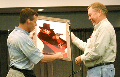 One of last year’s Lamont Award winners, Leigh Mechem, presents the 2006 Lamont Award to John Woolley during Saturday night’s events.