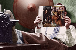 A man reads "G-Men" magazine