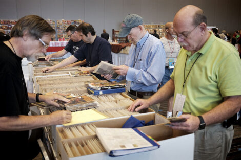 Digges La Touche (center) and other collectors search through boxes of pulps on the table of dealer Jon Wehler (left).