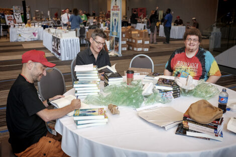 Authors Paul Spiteri, Win Scott Eckert, and Sean Lee Levin autograph books for Meteor House.