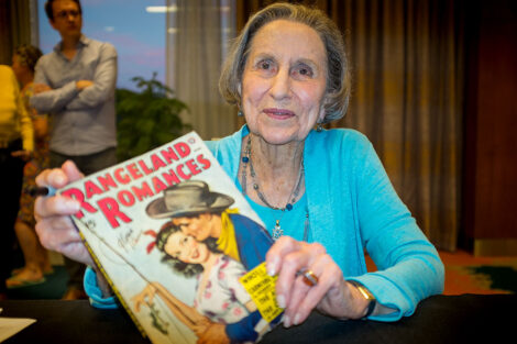 PulpFest Guest of Honor Gloria Stoll Karn graciously spent time after her presentation signing pulps featuring covers she painted.